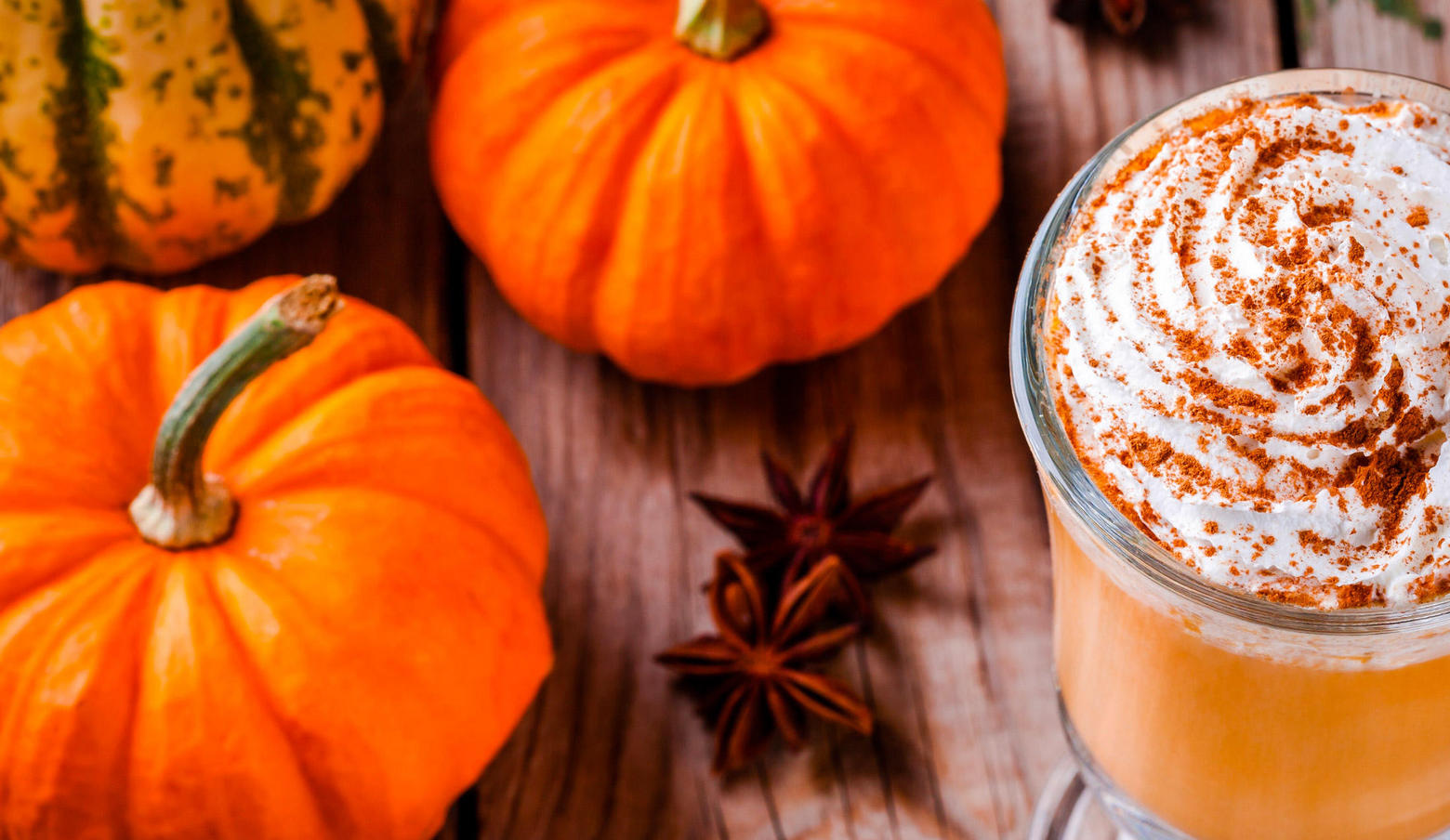 Pumpkin Spice Latte near mini orange pumpkins